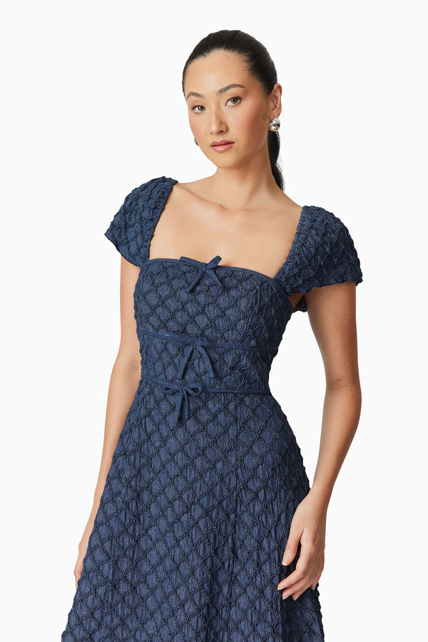 Brunette model wearing Keeley Midi Dress in Blue close up shot