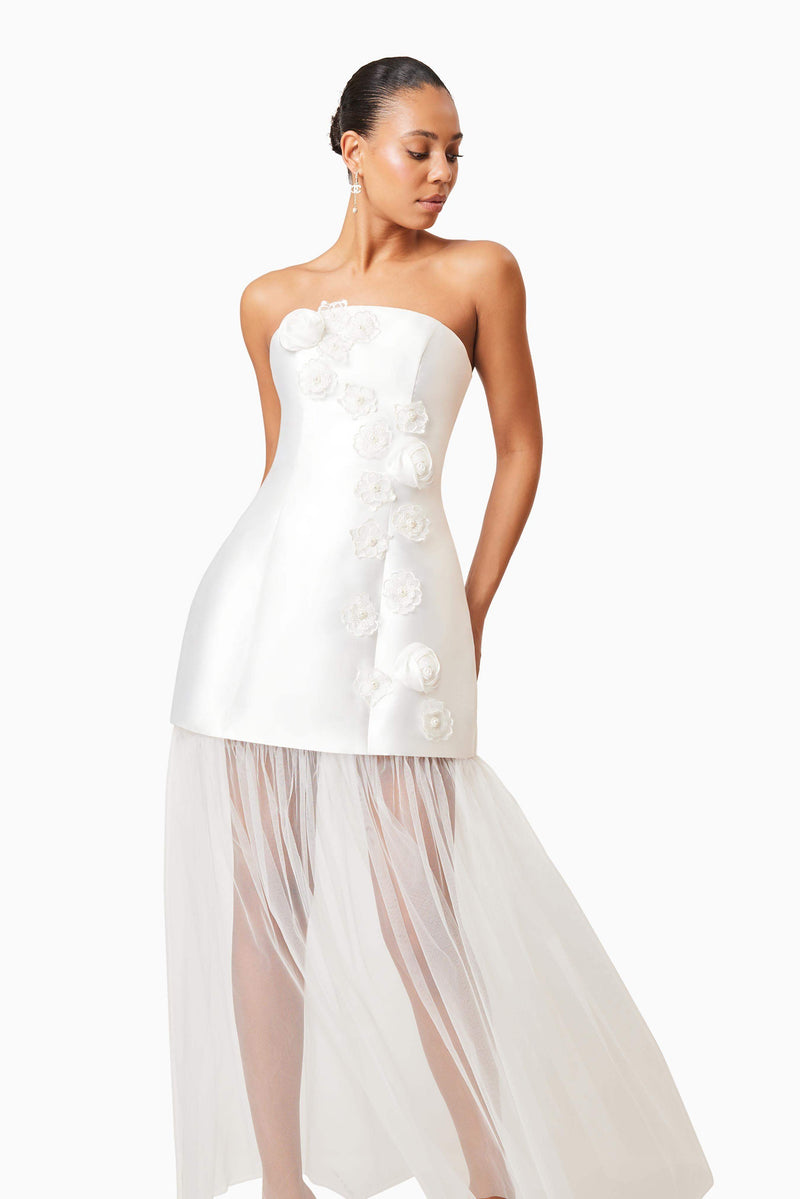 Brunette model wearing Oleander Strapless Maxi Dress In White looking away shot